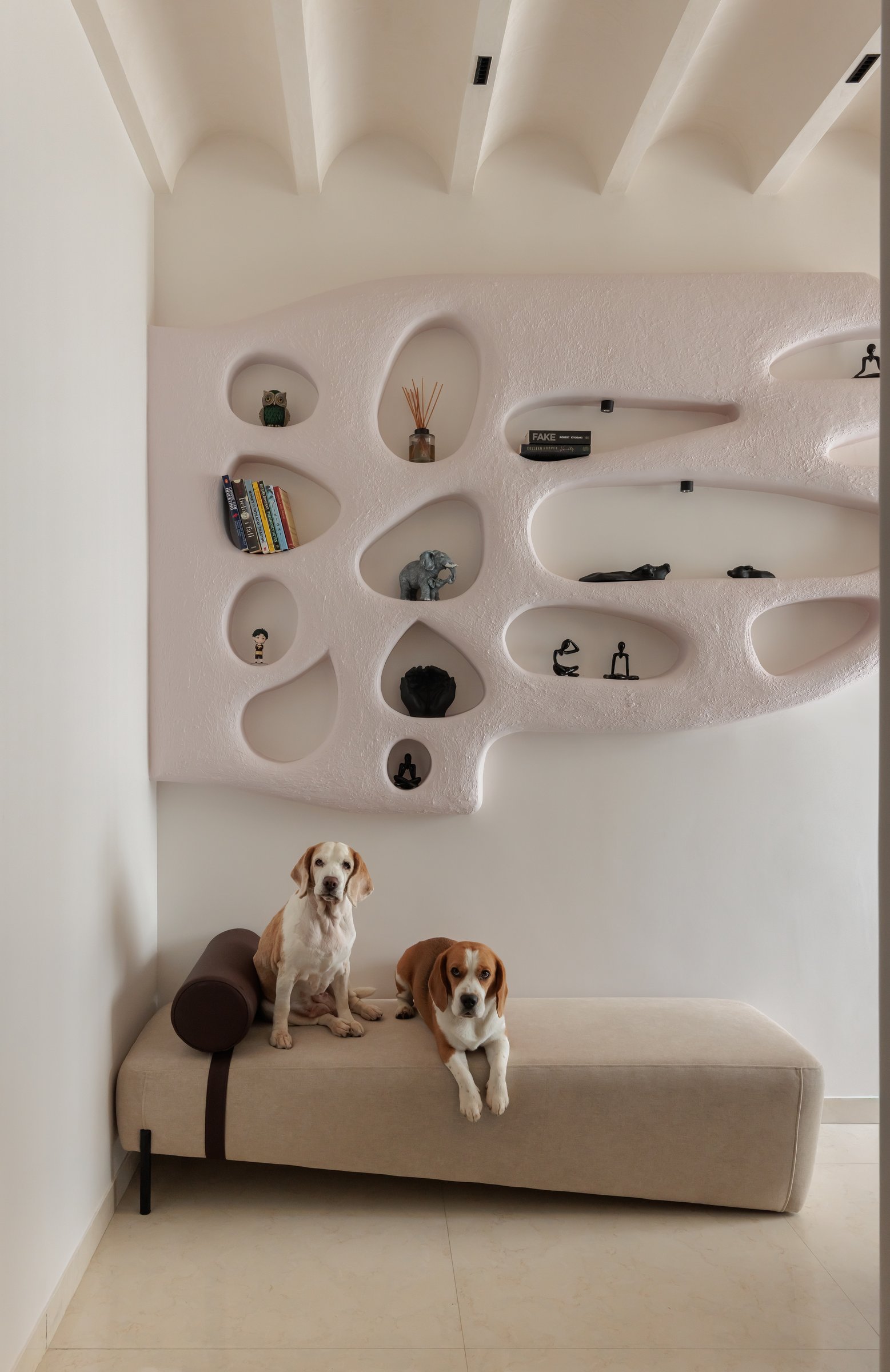 The sculpted plaster wall with organic openings, and a daybed shared with Ginger and Oliver