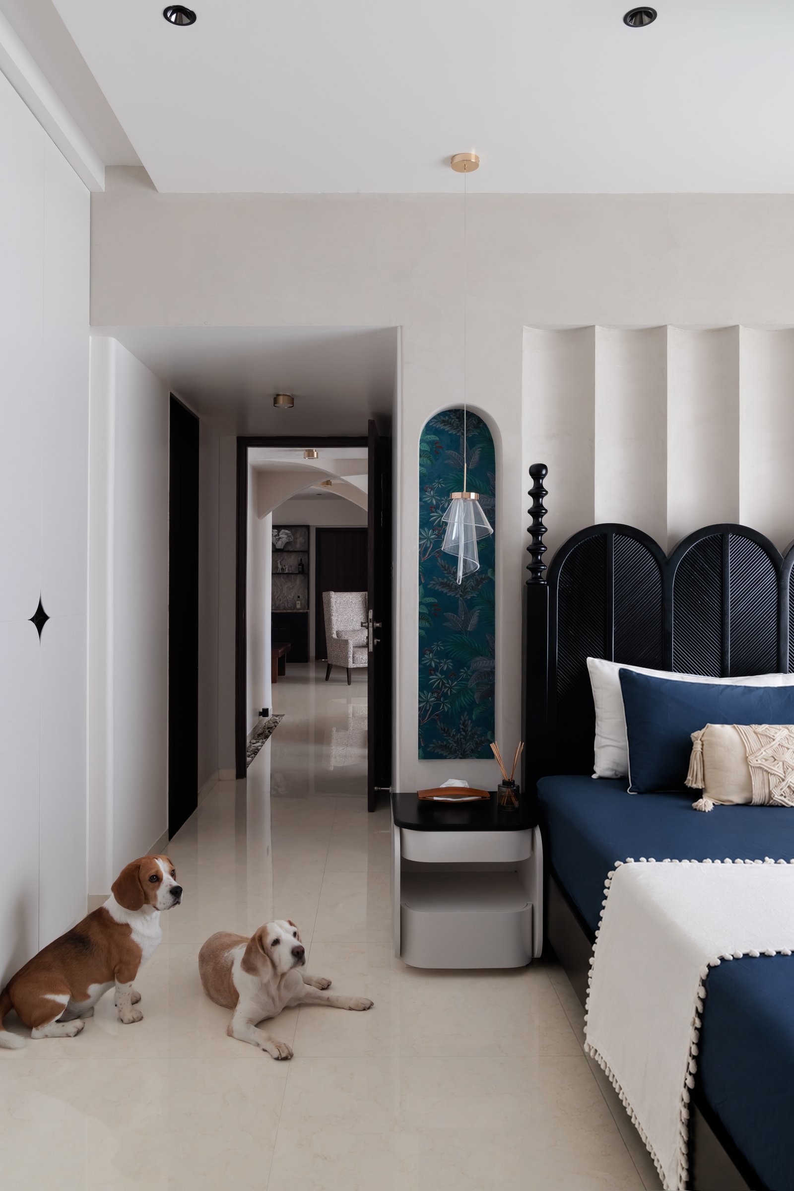 The bedroom's arched fluted headboard, set against a wall of soft vertical fluting