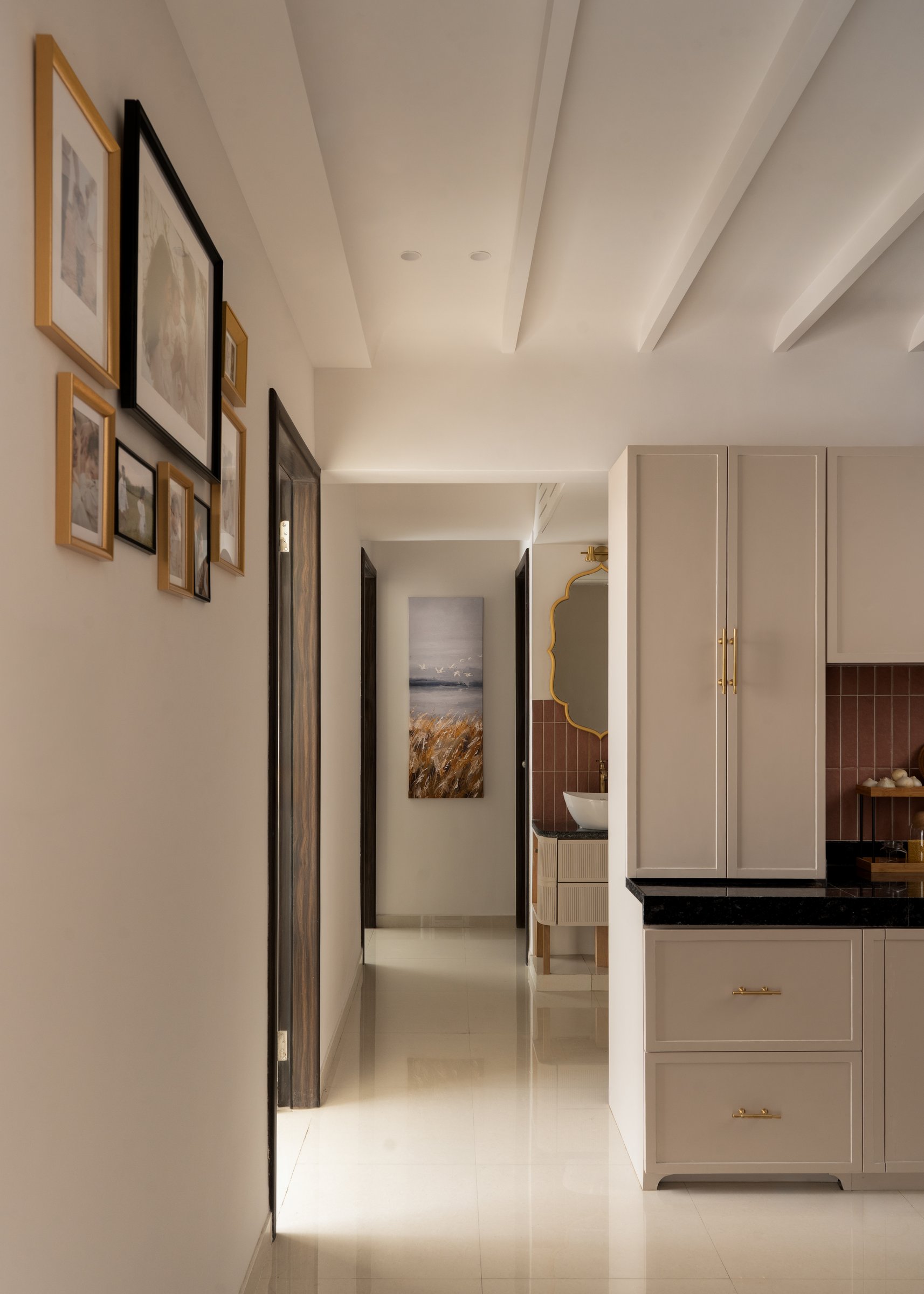 The circulation corridor, its gallery of framed prints and fluted ceiling tying the plan together