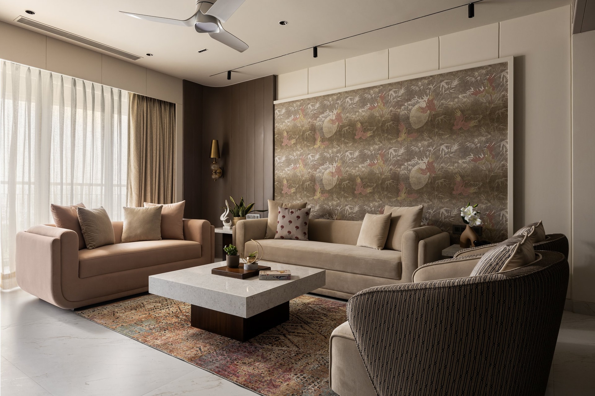 The living room, arranged around a framed birds-and-foliage panel that carries the room without insistence