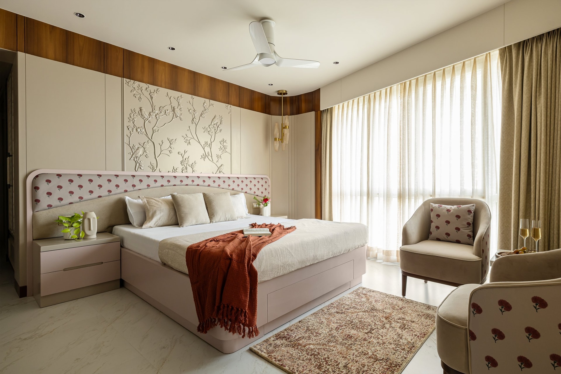 The master bedroom, where a sculpted relief panel of birds and branches forms the focal wall