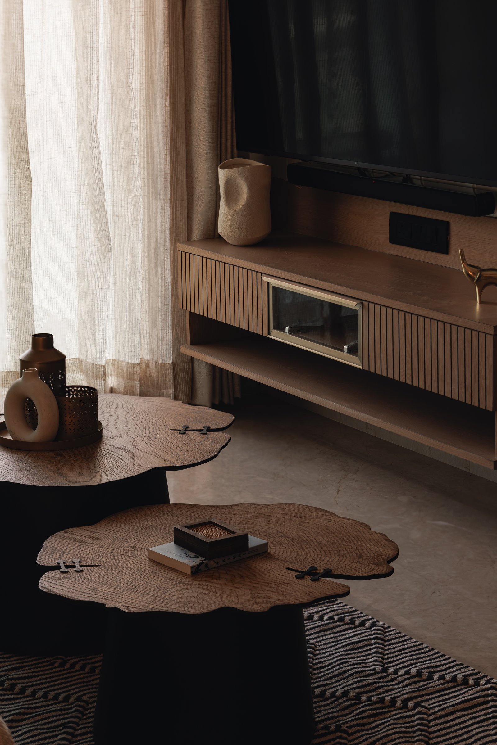 The coffee tables treated as sculpture, their cross-grained surfaces joined with small butterfly details