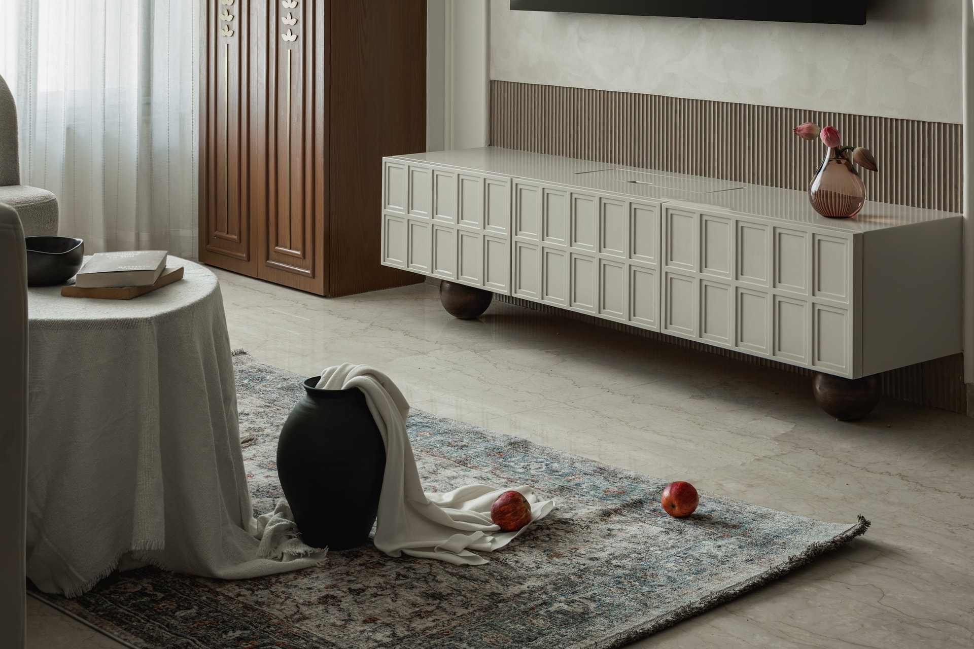 The media console, worked in a gridded relief pattern and set on turned wood ball feet