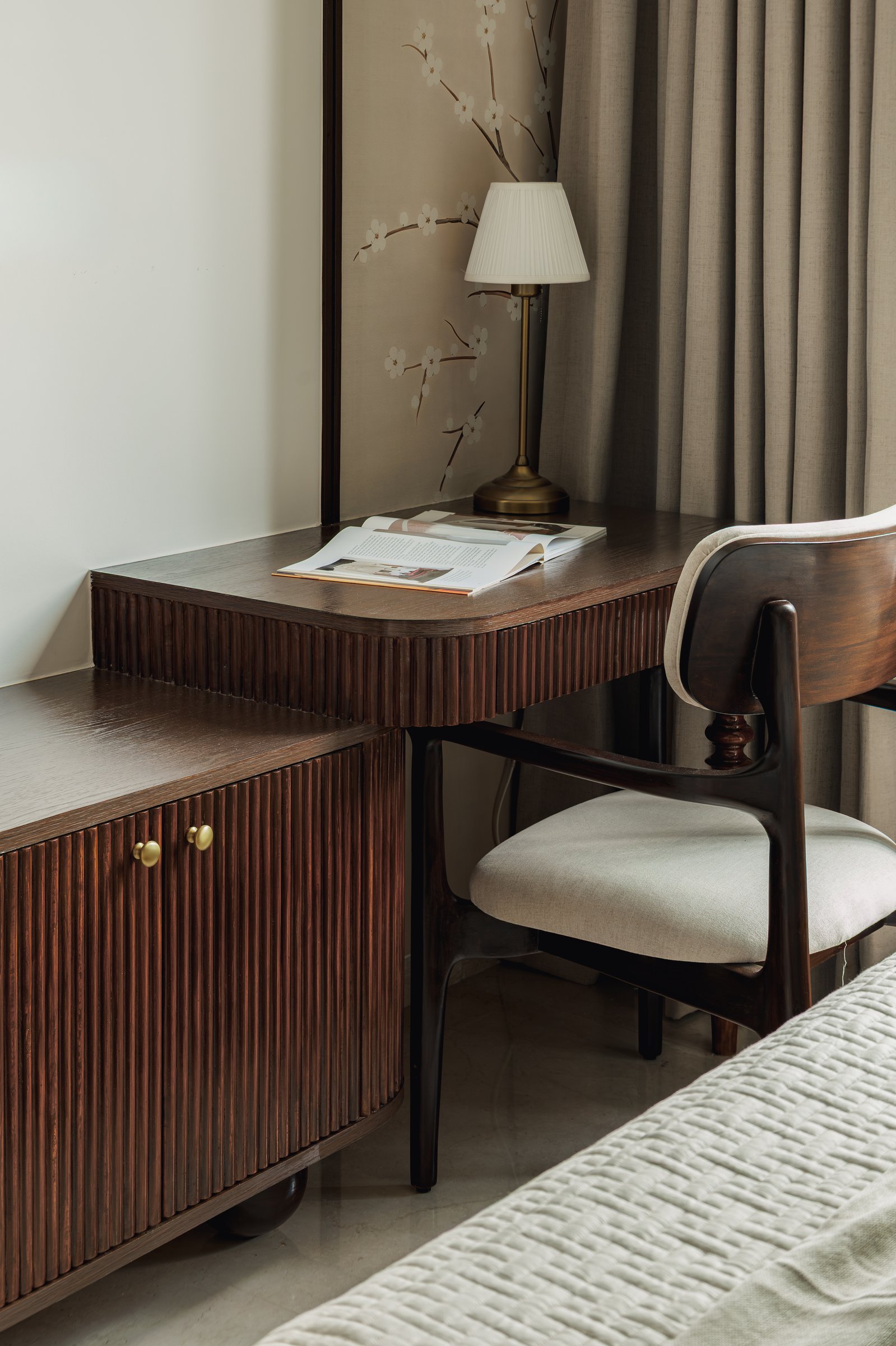 The writing desk in the primary bedroom, its reeded apron and cabinet pairing craftsmanship with restraint